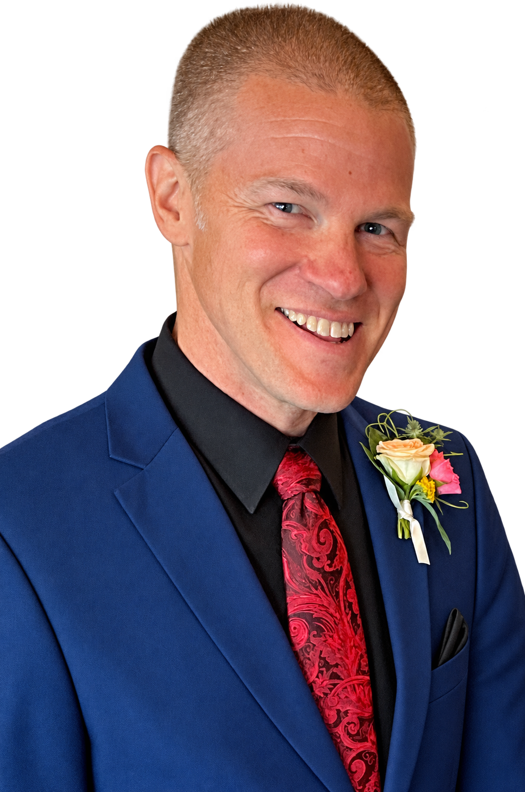 Brian Washburn smiling in a navy suit with a red tie and boutonniere.